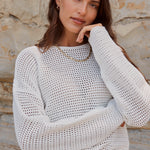 model wears white crochet knit cotton jumper