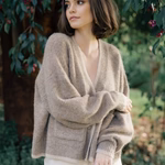 model wears a hazelnut brown beige cardigan