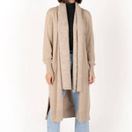 model wears a biege cardigan