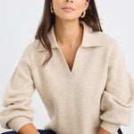 Model wears a beige knit collared jumper