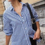 model wears a blue and white stripe shirt with a black skirt