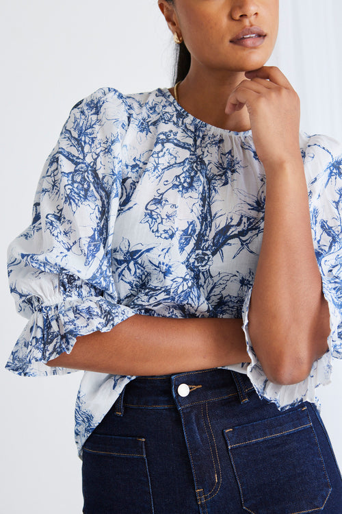 Model wears a blue floral top