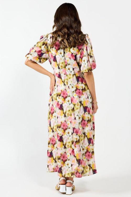 model wears a pink floral maxi dress