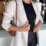 model wears a beige stripe blazer