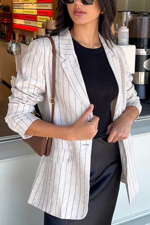 model wears a beige stripe blazer