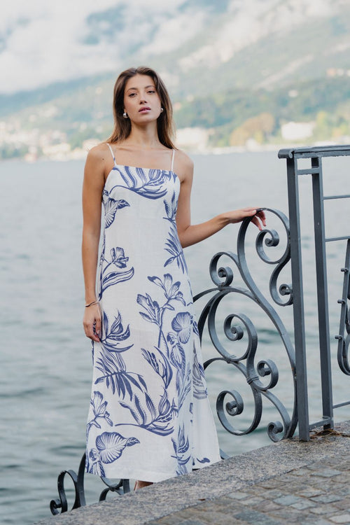 model wears a white and blue floral midi dress