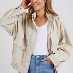 model wears a beige jacket