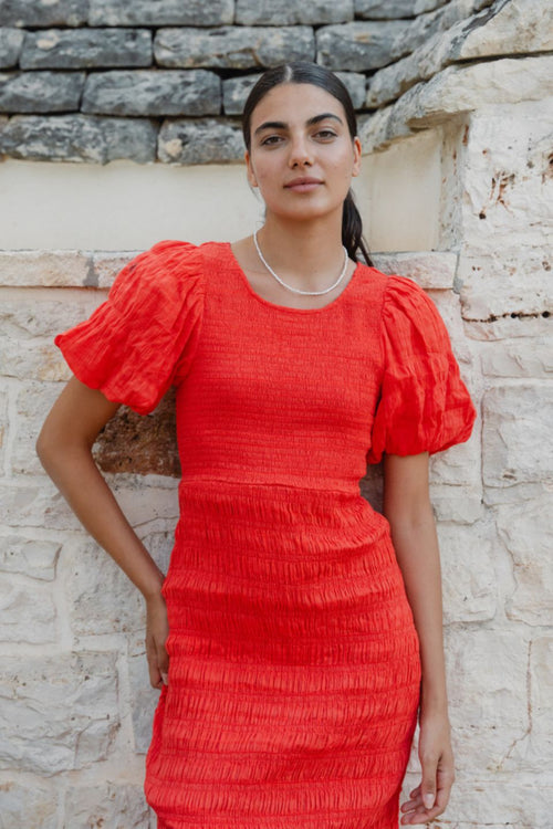 model wears a red puff sleeve midi dress