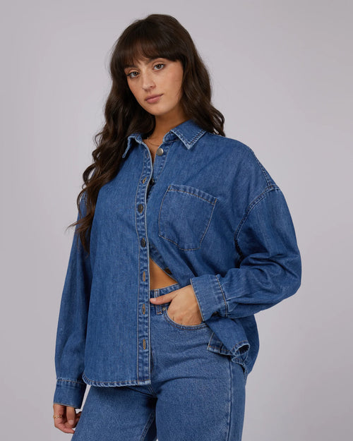 model wears dark denim shirt