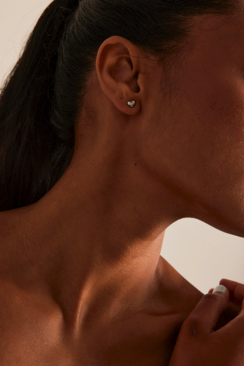 model wearing Bubble Heart Stud Rhodium Earrings