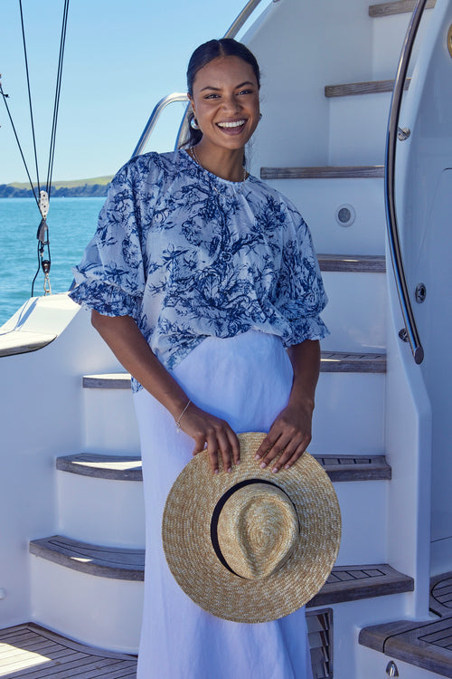 Model wears a blue floral top