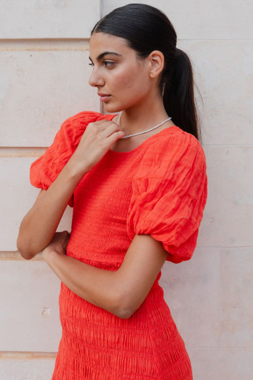 model wears a red puff sleeve midi dress