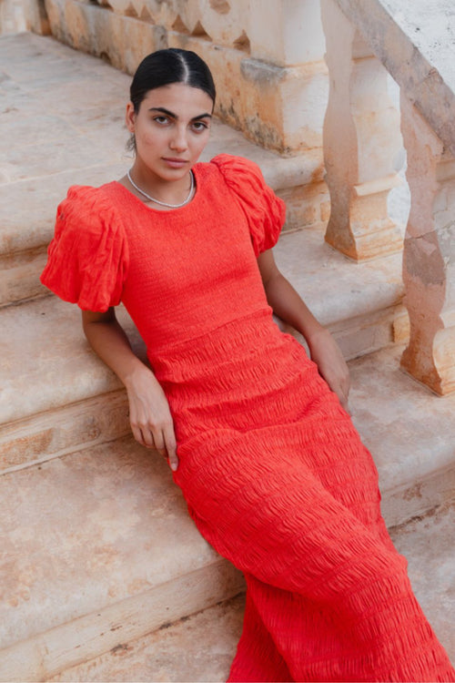 model wears a red puff sleeve midi dress