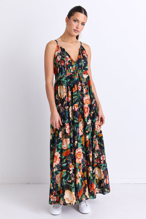 model wears a black floral maxi dress