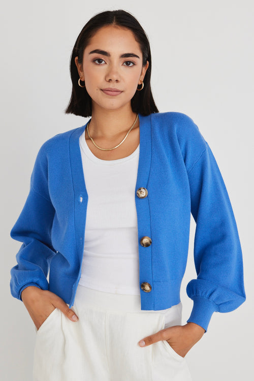 model wears a blue cardigan