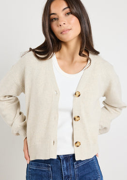 model wears a beige cardigan