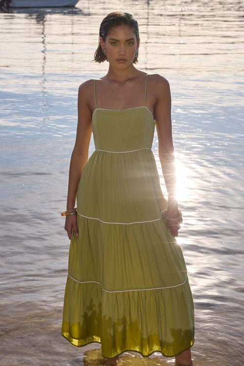 model wears a green midi dress