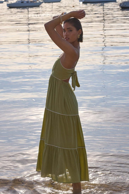 model wears a green midi dress