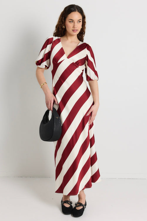 model wears a red and white stripe maxi dress