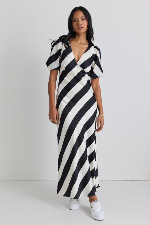 model wears a black and white stripe midi dress