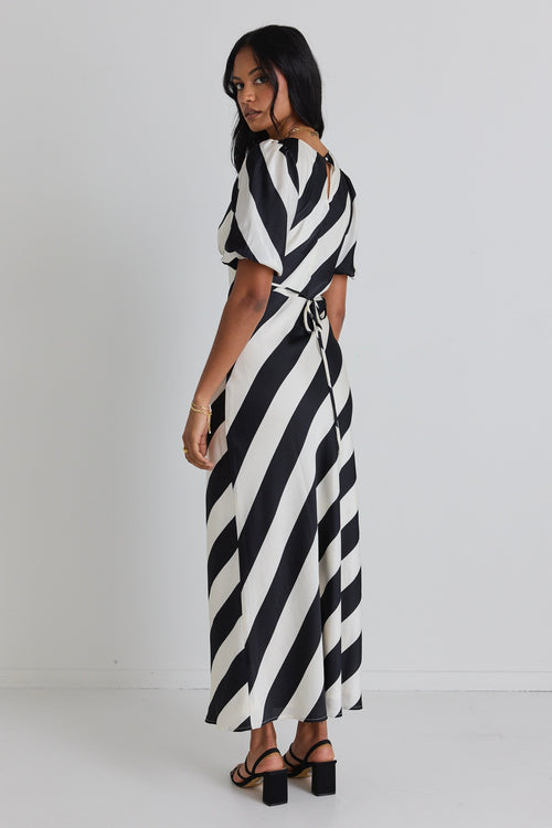 model wears a black and white stripe midi dress