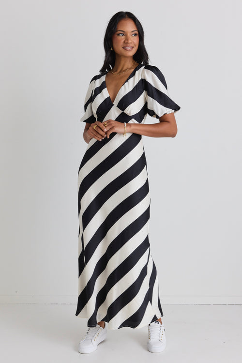 model wears a black and white stripe midi dress