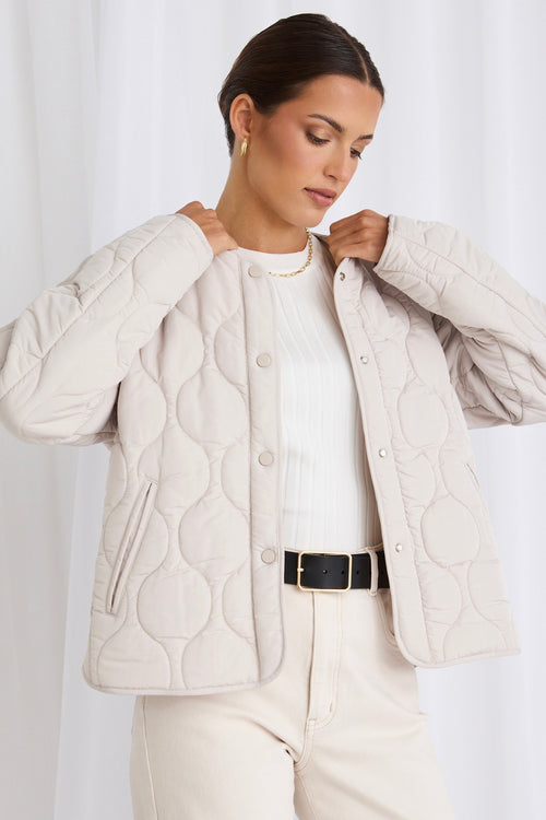 model wears a white puffer jacket