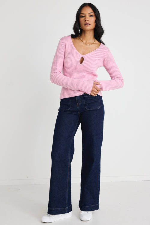 Model wears a pink long sleeve knit top