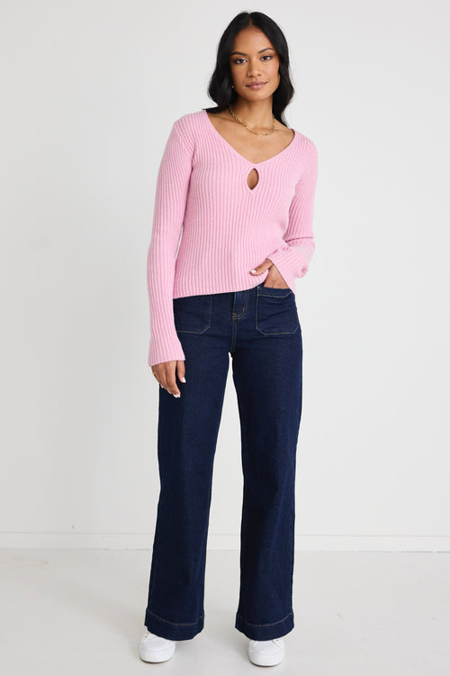 Model wears a pink long sleeve knit top