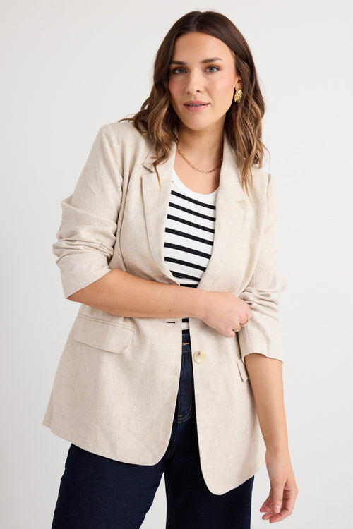 model wears a beige linen blazer