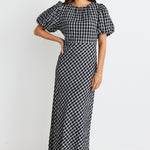 model wears a black and white check maxi dress