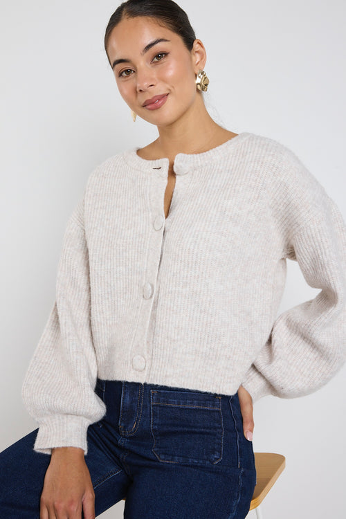 model wears a oat cropped cardigan with blue wide leg jean