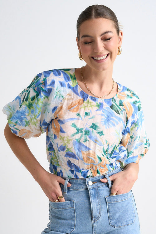 model wears a blue orange floral top