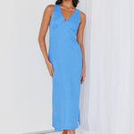 Model wears a linen maxi blue dress. 