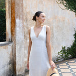 model wears linen v neck midi dress