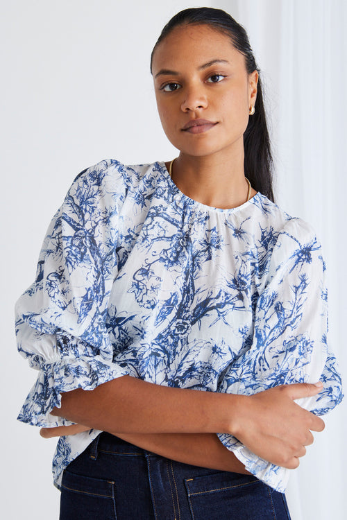 Model wears a blue floral top