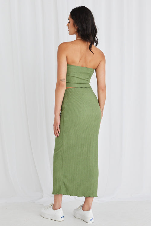 Model wearing green bandeau top and maxi skirt set