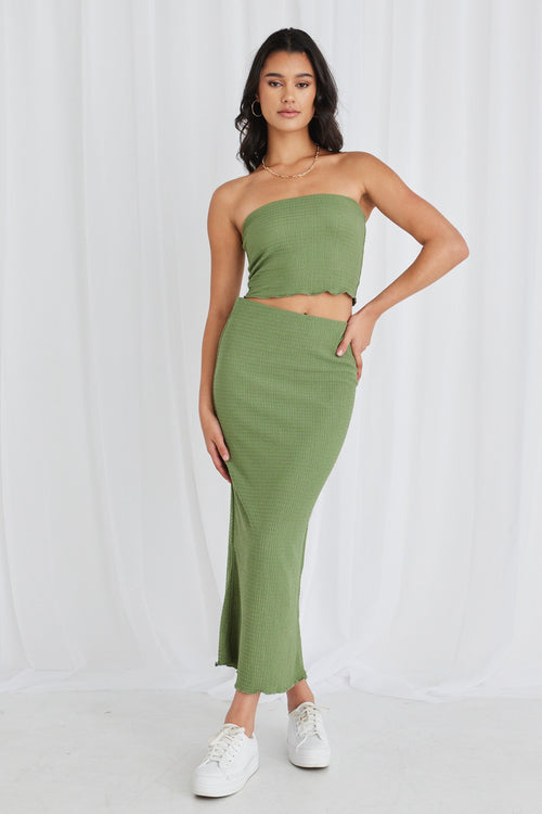 Model wearing green bandeau top and maxi skirt set