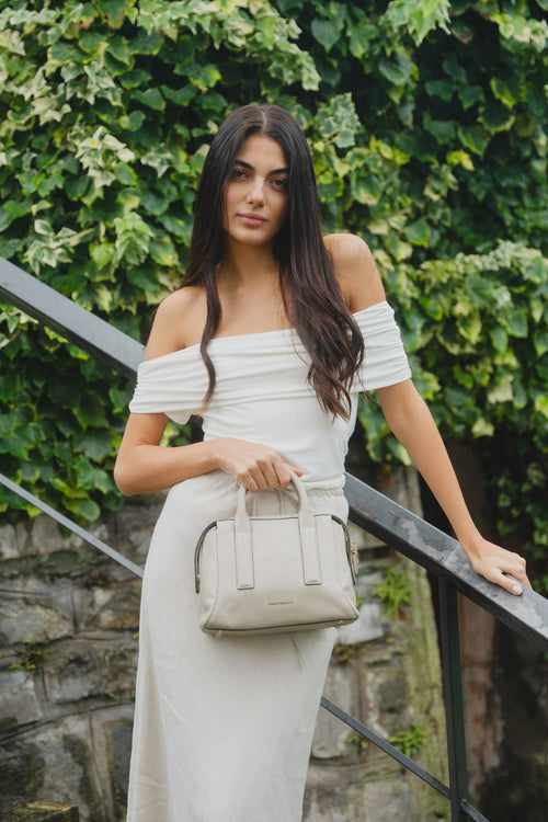 Model wears a white off shoulder top 