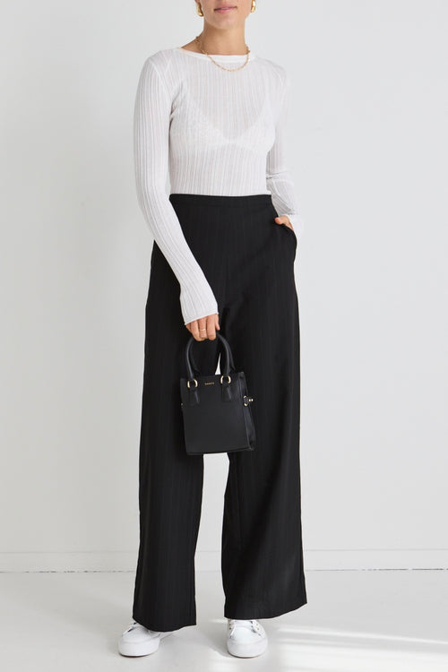 model wears black wide leg pants