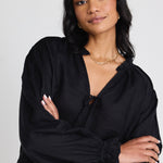 model wears a black linen long sleeve top