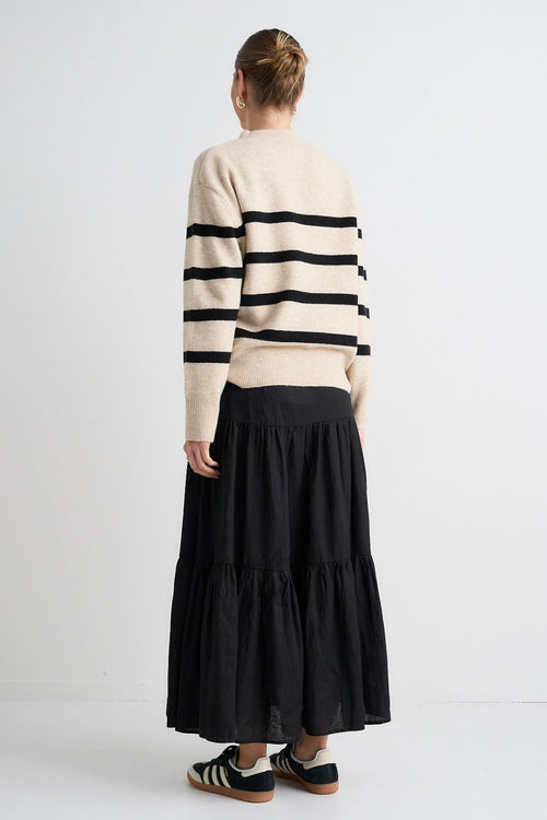 model wears a beige stripe knit model wears a beige stripe knit and a black linen skirt