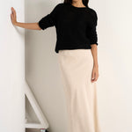 model wears a natural linen midi skirt