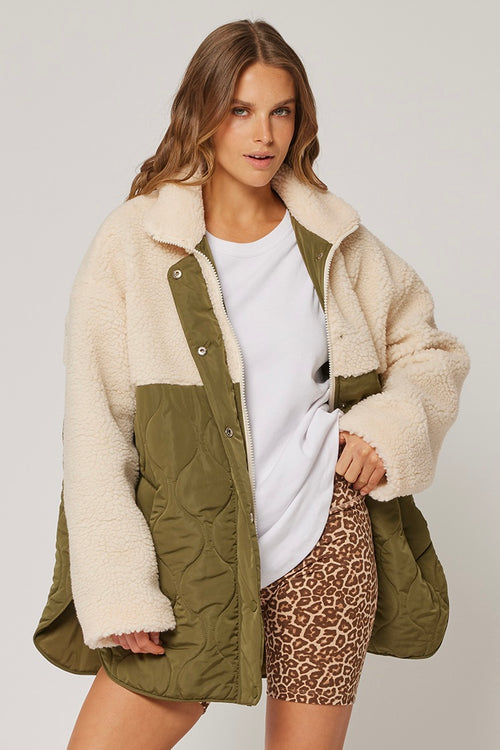 model wears a cream green jacket