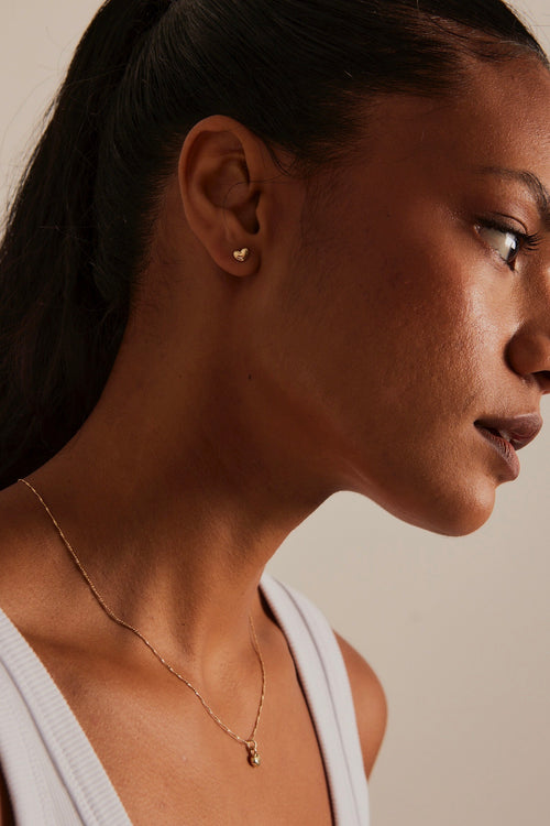 model wearing Bubble Heart Stud Gold Earrings