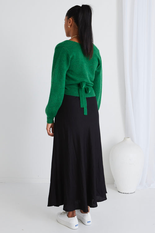 model wears a green wrap knit