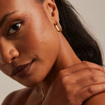 model wearing Chunky Oval Gold Hoop Earrings