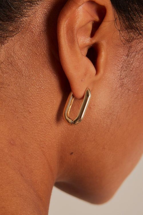 model wearing Chunky Oval Gold Hoop Earrings