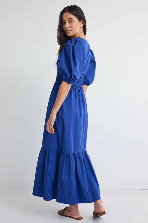 model wears a blue maxi dress