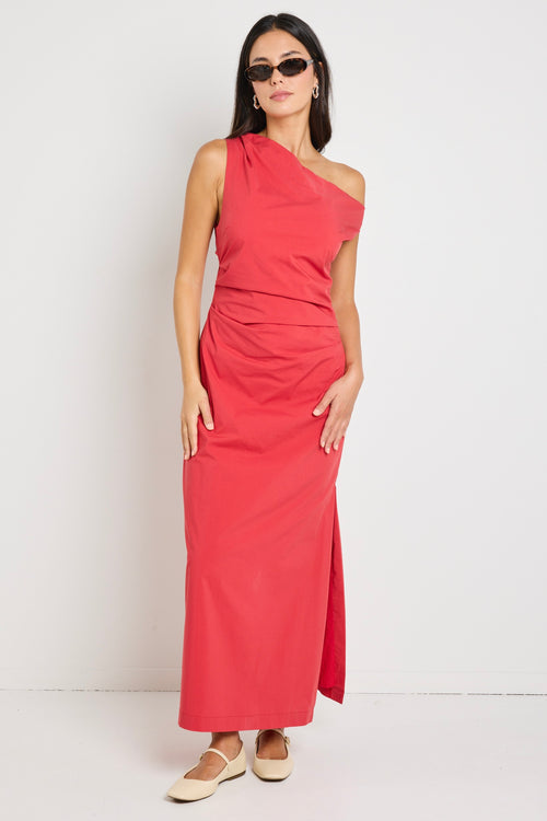 Woman wearing a bold red one-shoulder dress with flattering ruching, perfect for a glamorous night out.